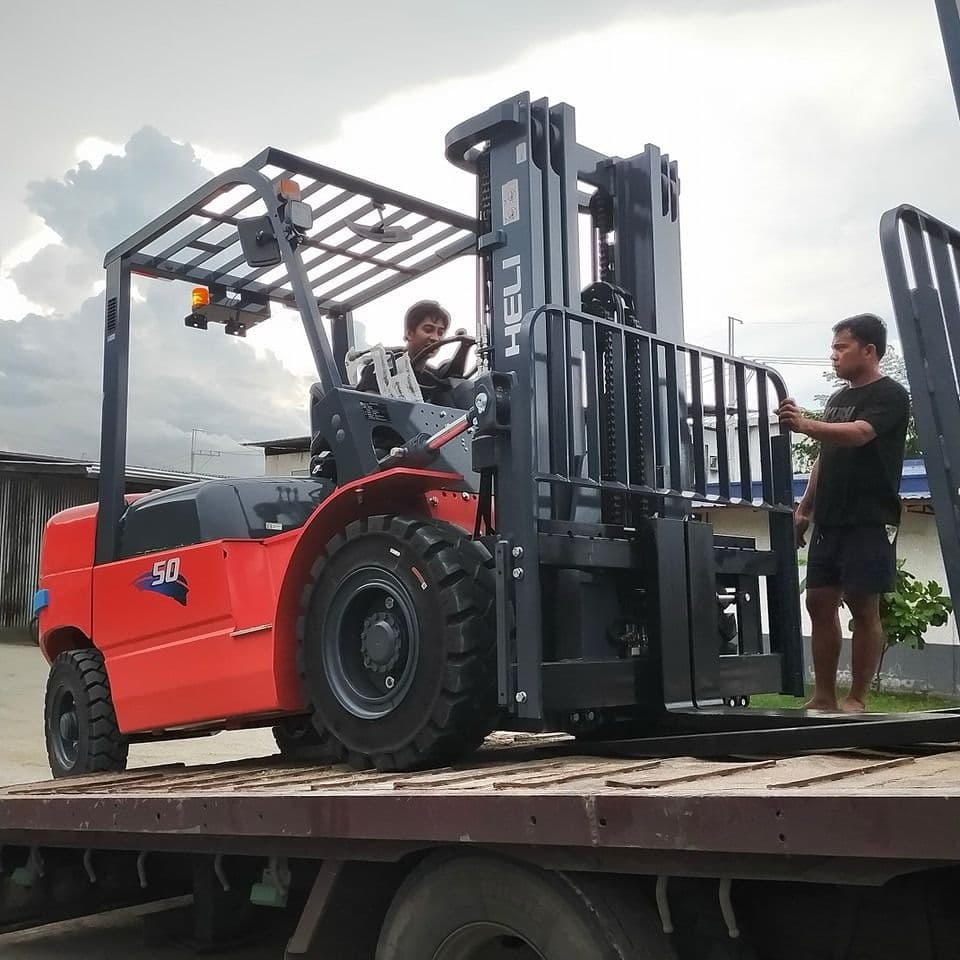 Red HELI forklift with operator and assistant